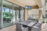 An outdoor SMART TV and plenty of patio seating